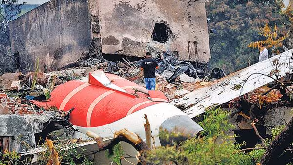 A-firefighter-stands-next-to-the-crashed-Air-India_1752289476862_1752289483618